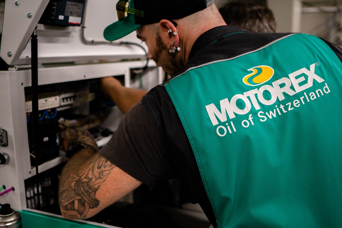 Service technician in a MOTOREX vest working on a fluid management unit