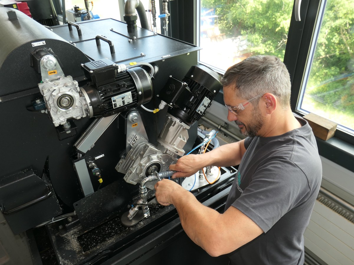 Service technician working inside a machine tool